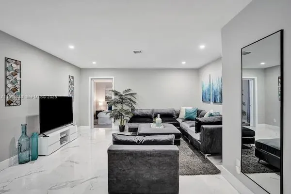 a living room with fireplace furniture and a flat screen tv
