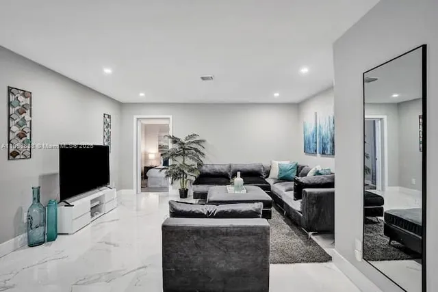 a living room with fireplace furniture and a flat screen tv