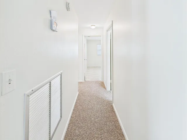 a view of a hallway with white walls