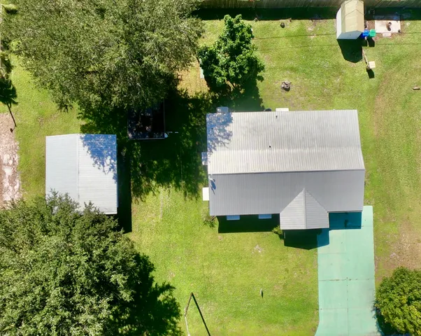 an aerial view of a house with swimming pool
