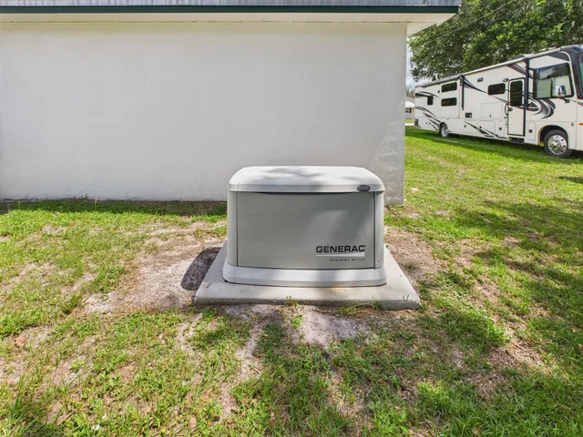 a view of a back yard of the house with green space
