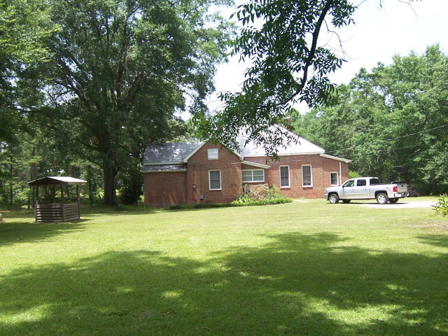 5500 Sardis Church Road Macon, GA 31216 - Photo 7 of 10 a front view of a house with yard and green space