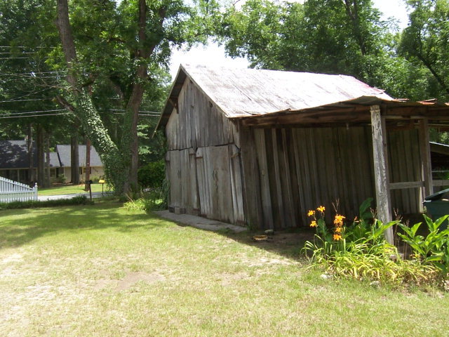 5500 Sardis Church Road Macon, GA 31216 - Photo 8 of 10 a backyard of a house with plants and tree with wooden fence