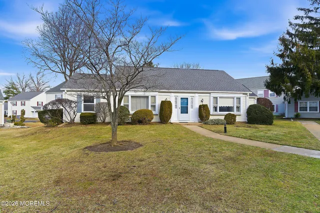 a view of a yard with a house in the background