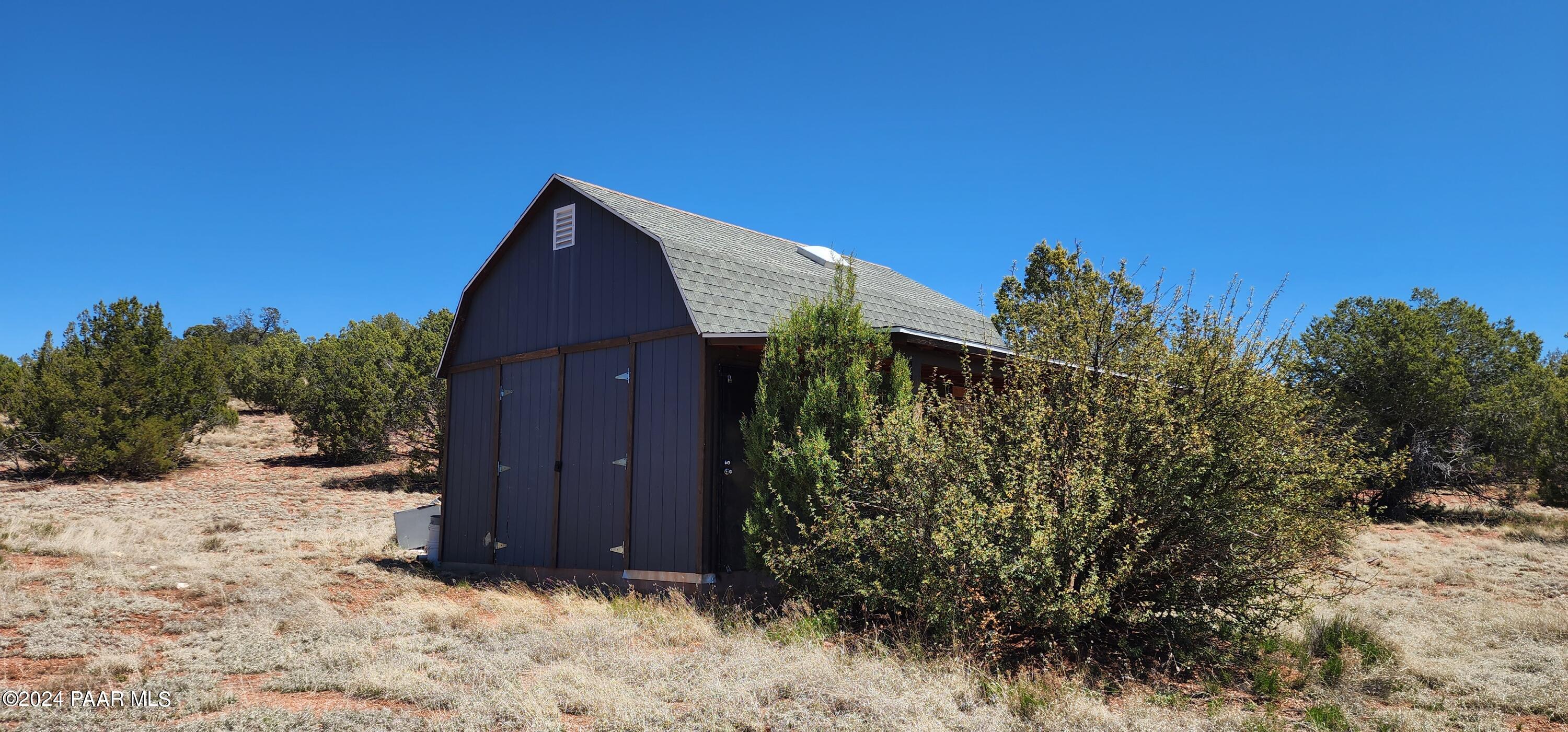 0 Wooden Ear Ranch Road Seligman, AZ 86337 - Photo 12 of 47 a backyard of a house with wooden fence and trees