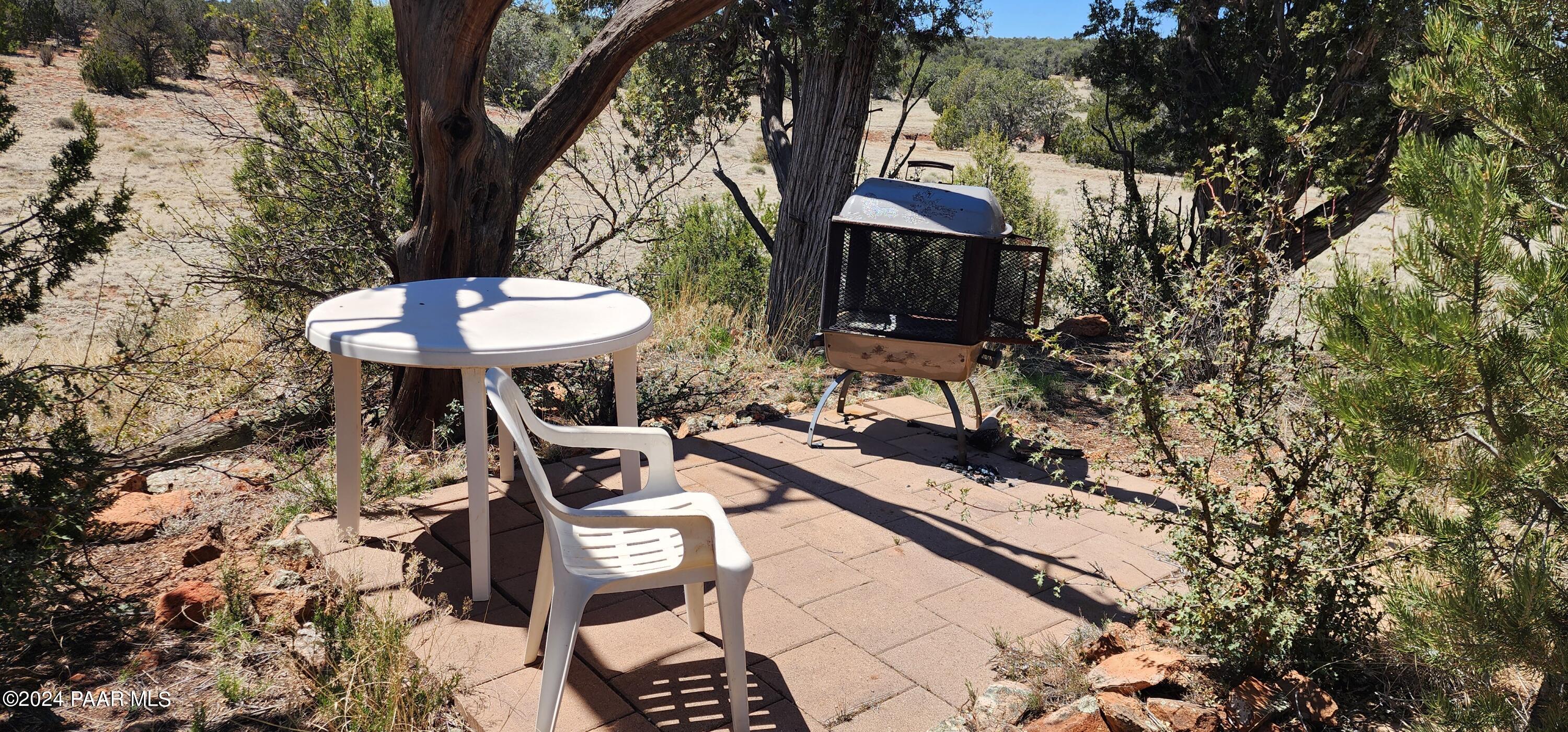 0 Wooden Ear Ranch Road Seligman, AZ 86337 - Photo 28 of 47 a front view of a house with a yard fire pit table and chairs