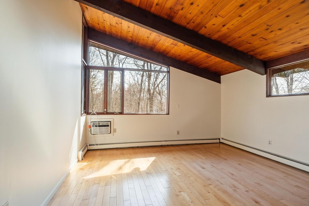 21 Gray Road Andover, MA 01810 - Photo 16 of 38 an empty room with wooden floor and windows