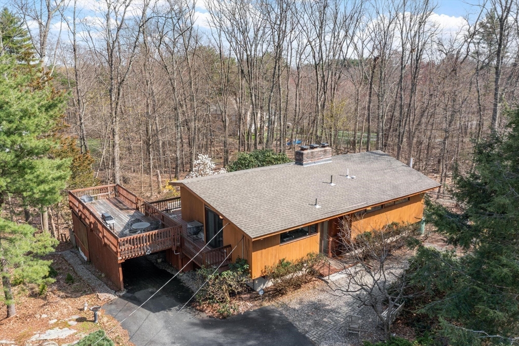 21 Gray Road Andover, MA 01810 - Photo 35 of 38 a view of a backyard with a small deck and a patio