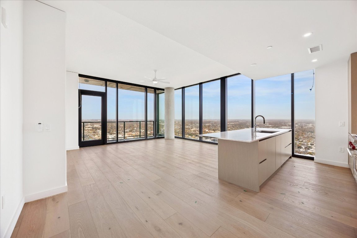 610 Davis Street, Unit 5007 Austin, TX 78701 - Photo 30 of 33 Kitchen / Living area with open floor plan, floor to ceiling windows, modern cabinets, light wood finished floors, and healthy amount of natural light
