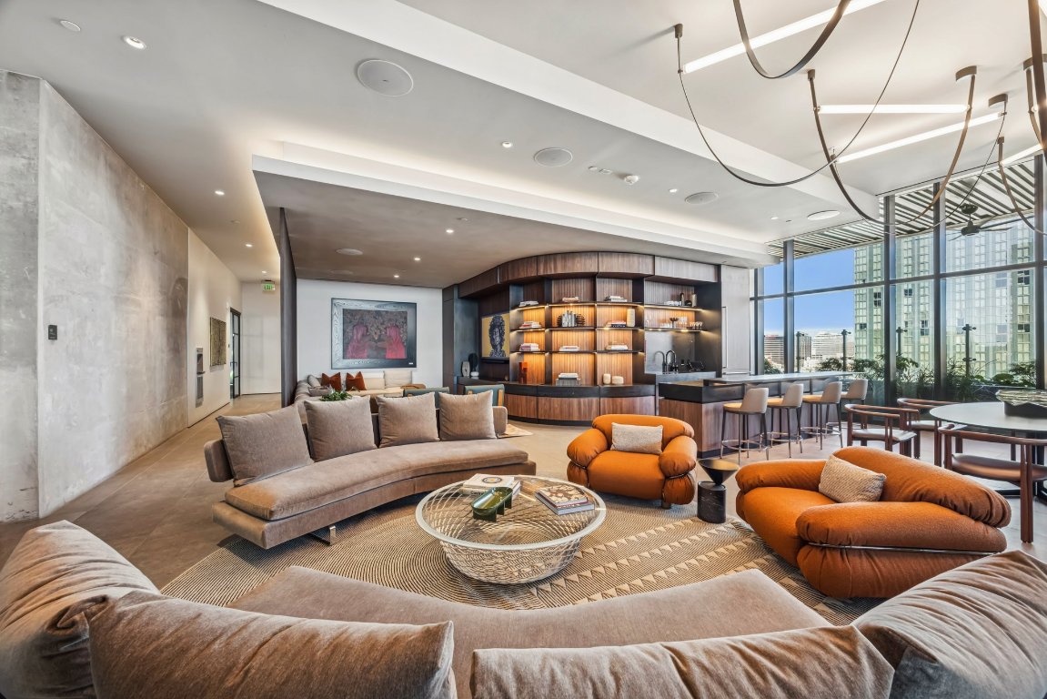 610 Davis Street, Unit 5007 Austin, TX 78701 - Photo 19 of 33 Amenity area with expansive windows and recessed lighting