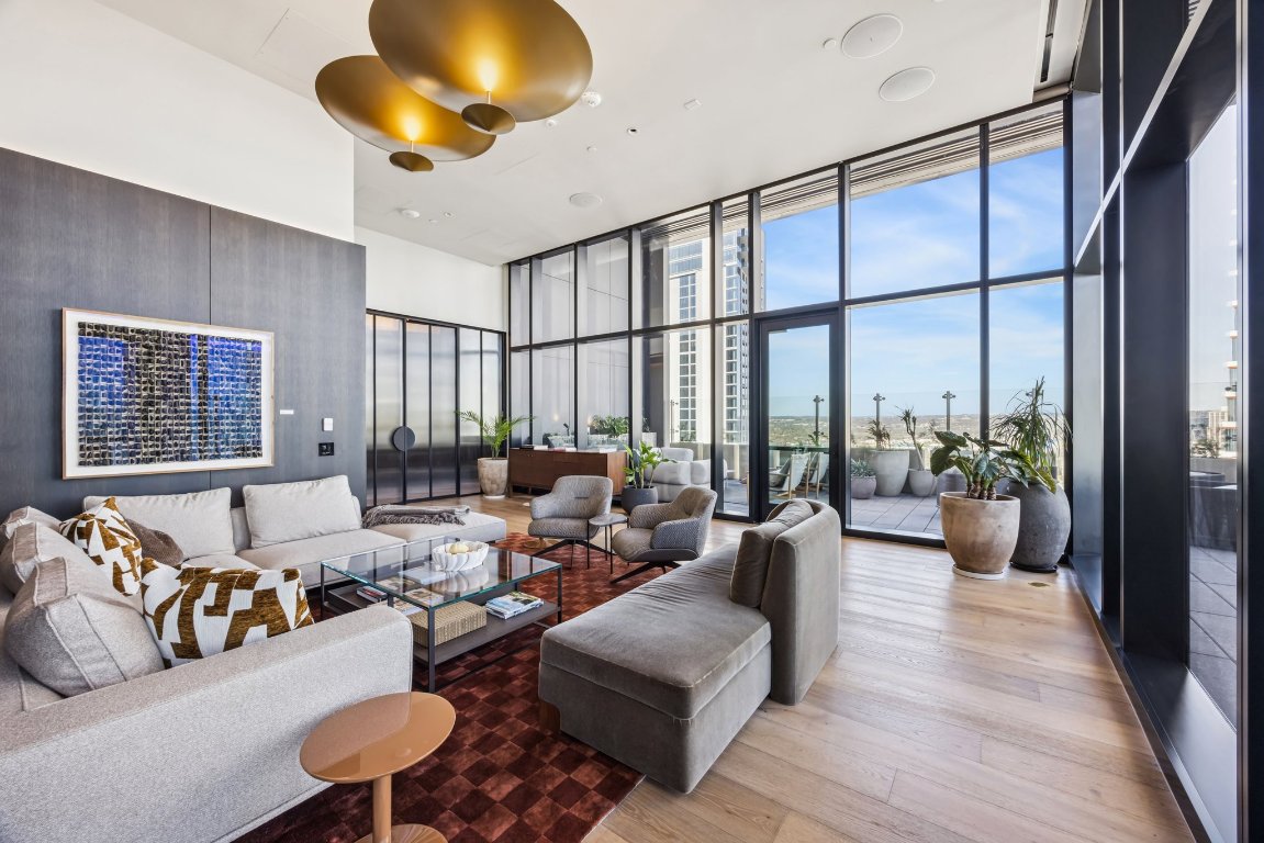 610 Davis Street, Unit 5007 Austin, TX 78701 - Photo 29 of 33 34th Floor amenity area with a high ceiling, a wall of windows, and wood finished floors