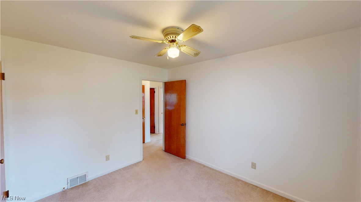 3520 Kirk Road Youngstown, OH 44511 - Photo 13 of 31 Spare room with light colored carpet and ceiling fan
