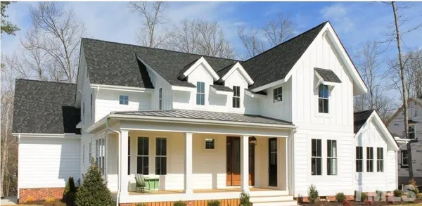 a view of a white house with large windows