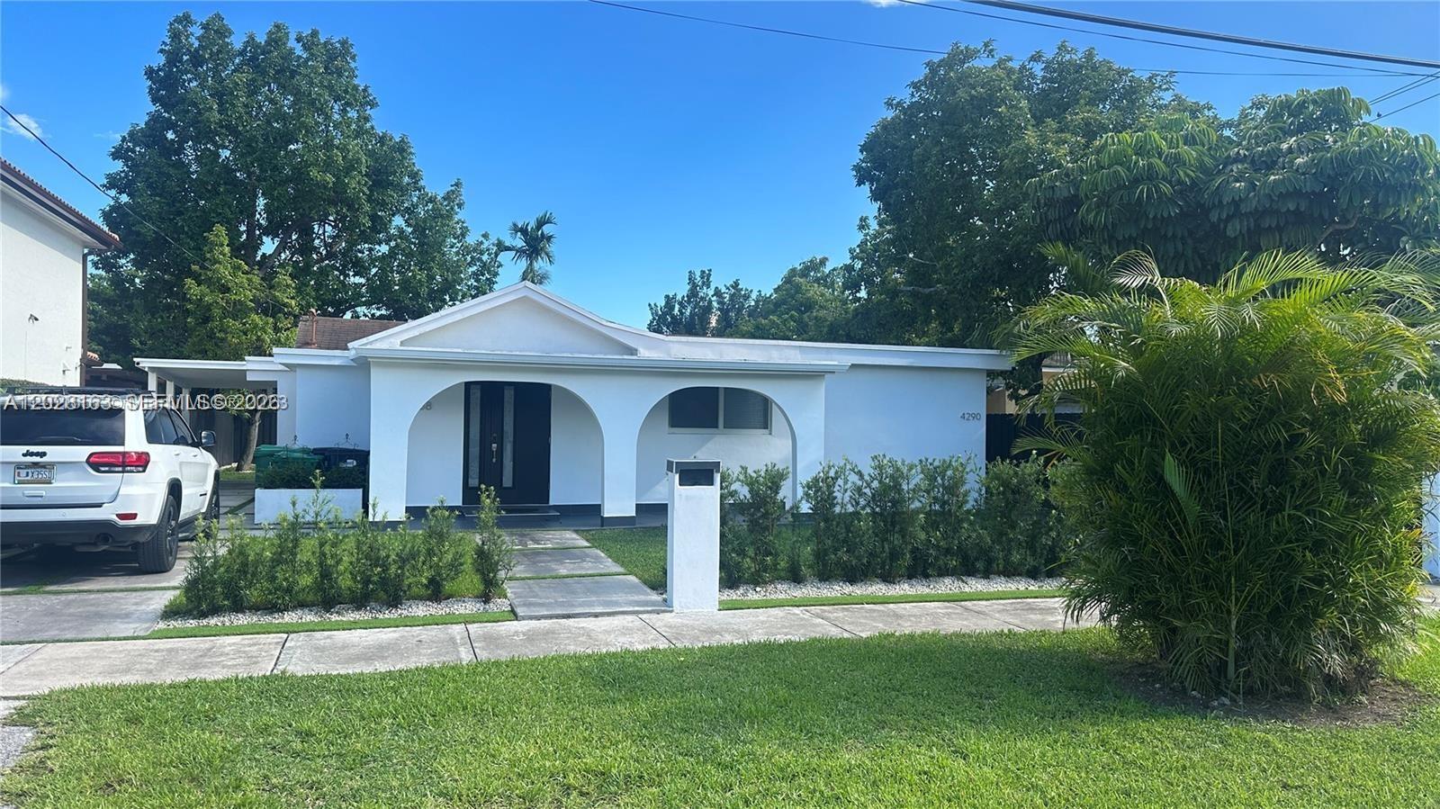 4290 Southwest 9th Street, Unit B Miami, FL 33134 - Photo 1 of 18 a front view of a house with a yard