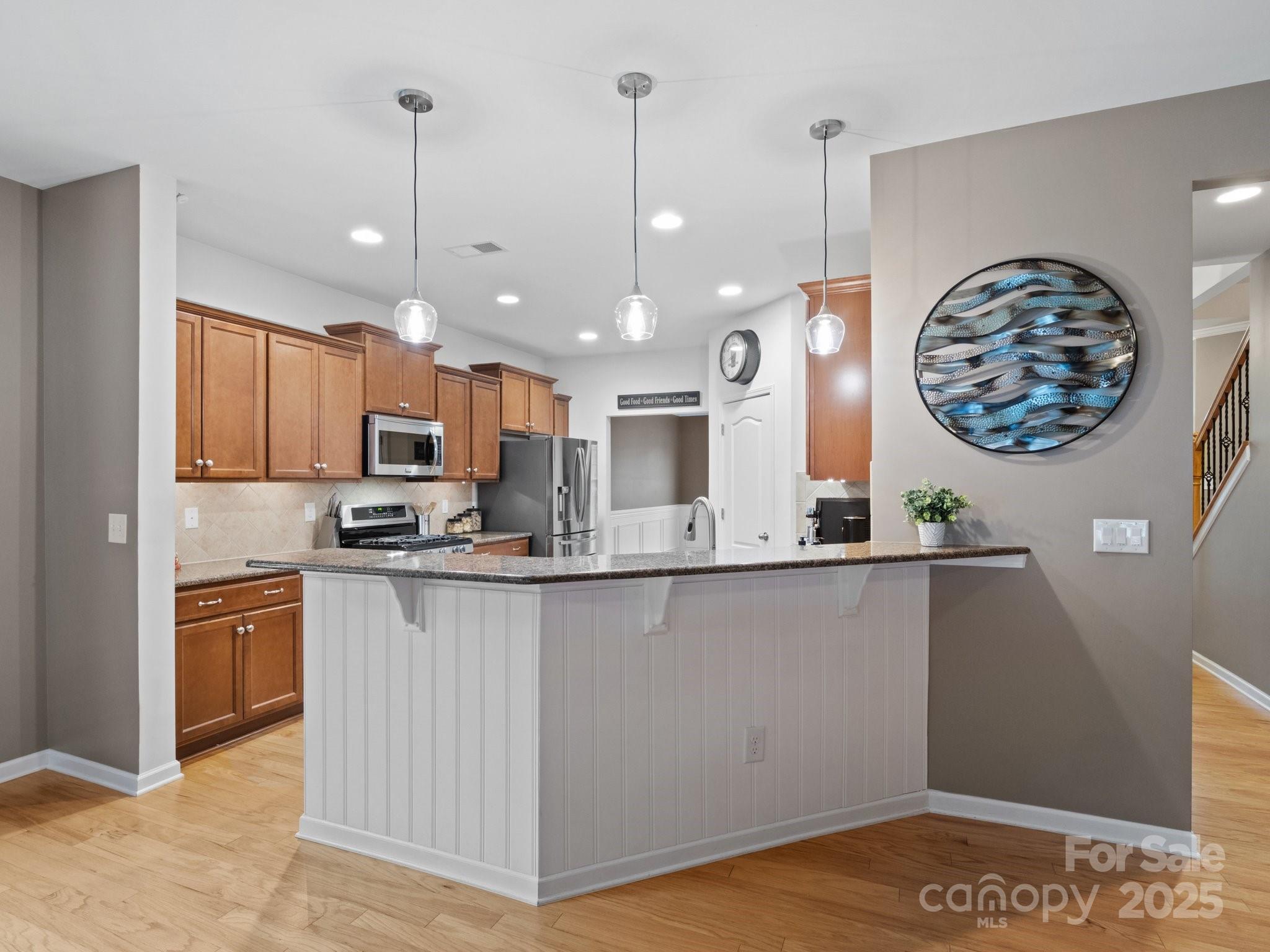 1033 Crawford Drive Lancaster, SC 29720 - Photo 16 of 48 a kitchen with stainless steel appliances granite countertop a sink a stove and a wooden floors