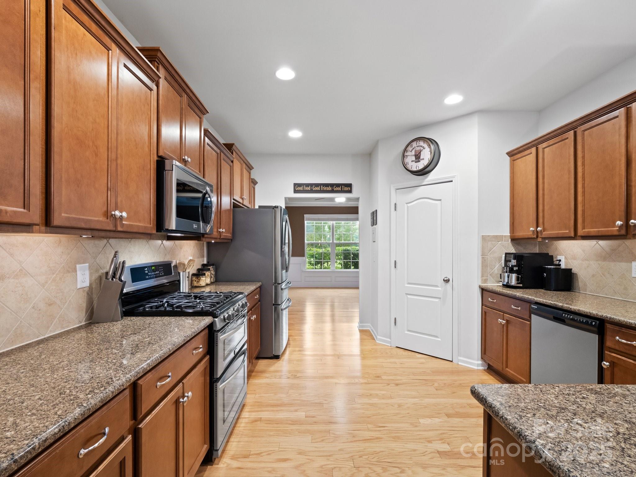 1033 Crawford Drive Lancaster, SC 29720 - Photo 17 of 48 a kitchen with stainless steel appliances granite countertop wooden cabinets a stove top oven a sink and dishwasher