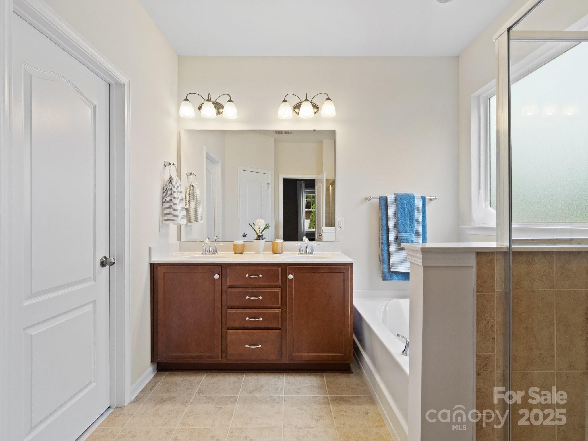 1033 Crawford Drive Lancaster, SC 29720 - Photo 23 of 48 a spacious bathroom with a bathtub sink and mirror