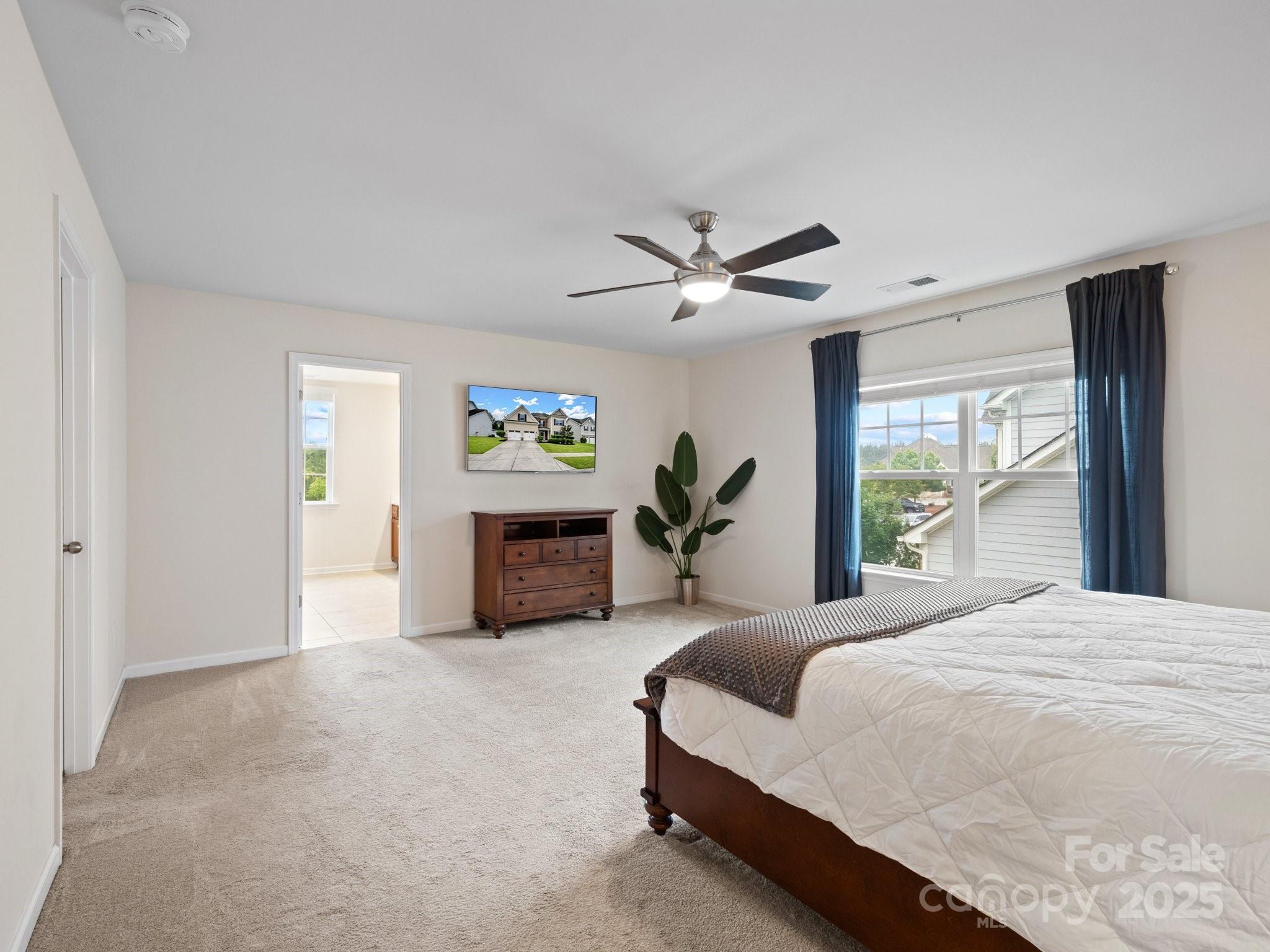 1033 Crawford Drive Lancaster, SC 29720 - Photo 27 of 48 a spacious bedroom with a bed and a chandelier