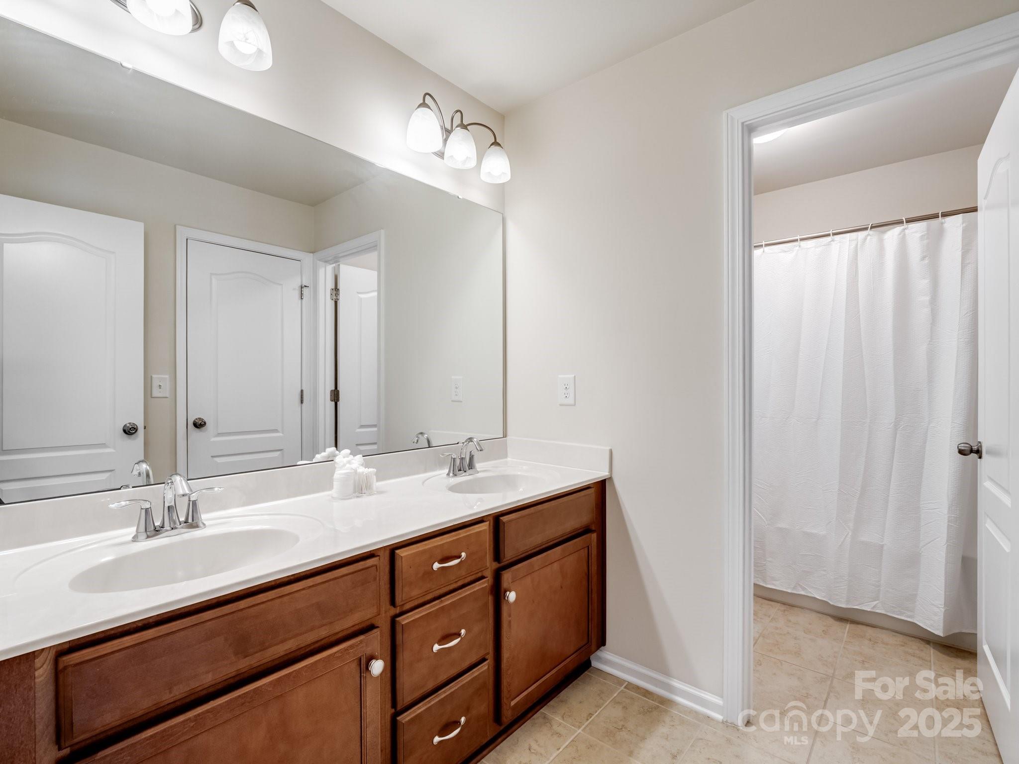 1033 Crawford Drive Lancaster, SC 29720 - Photo 32 of 48 a bathroom with double sink and a mirror
