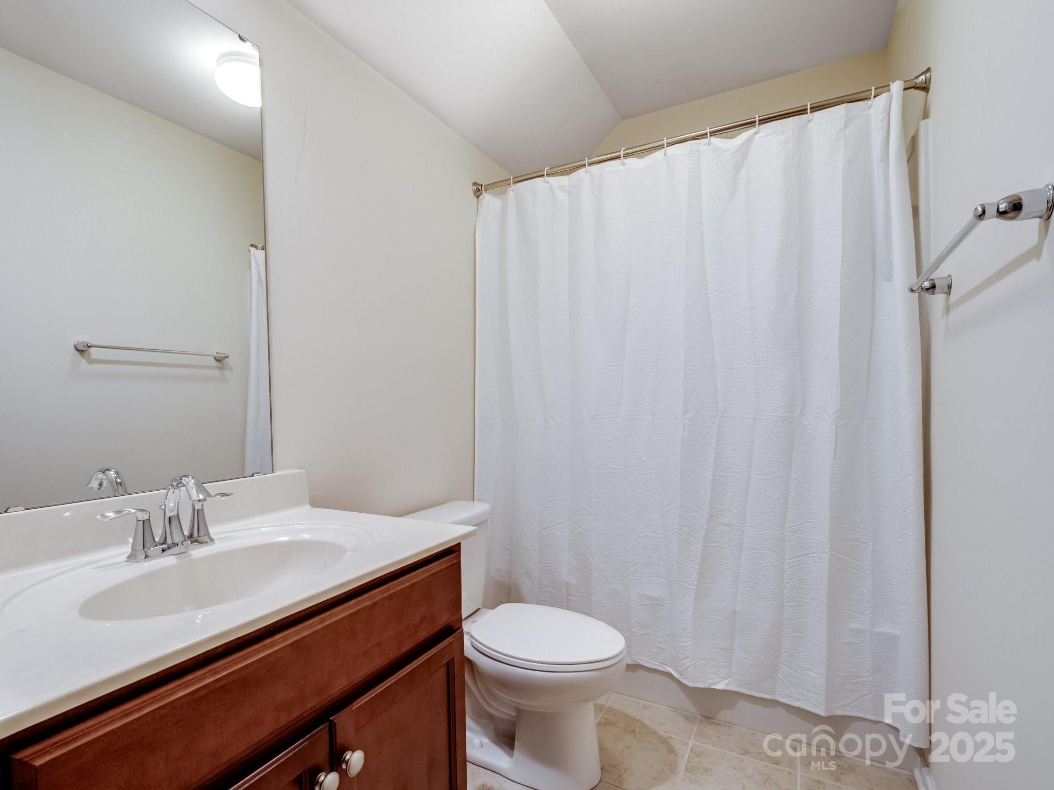 1033 Crawford Drive Lancaster, SC 29720 - Photo 38 of 48 a bathroom with a sink a toilet and shower curtain