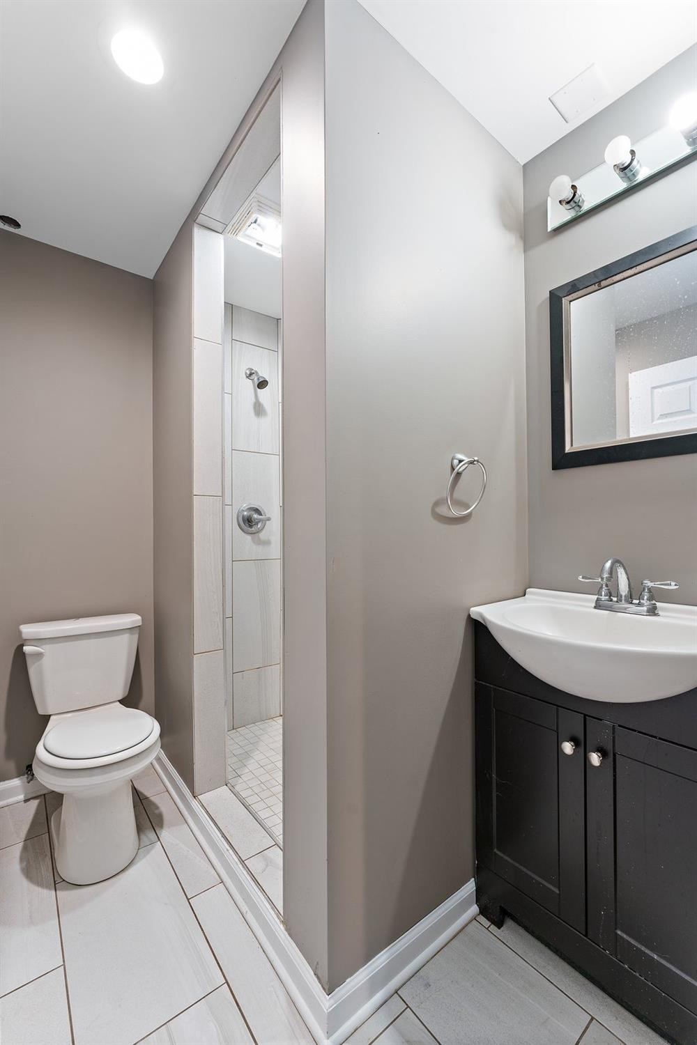 10983 Potomac Drive Demotte, IN 46310 - Photo 14 of 18 a bathroom with a toilet a sink and mirror