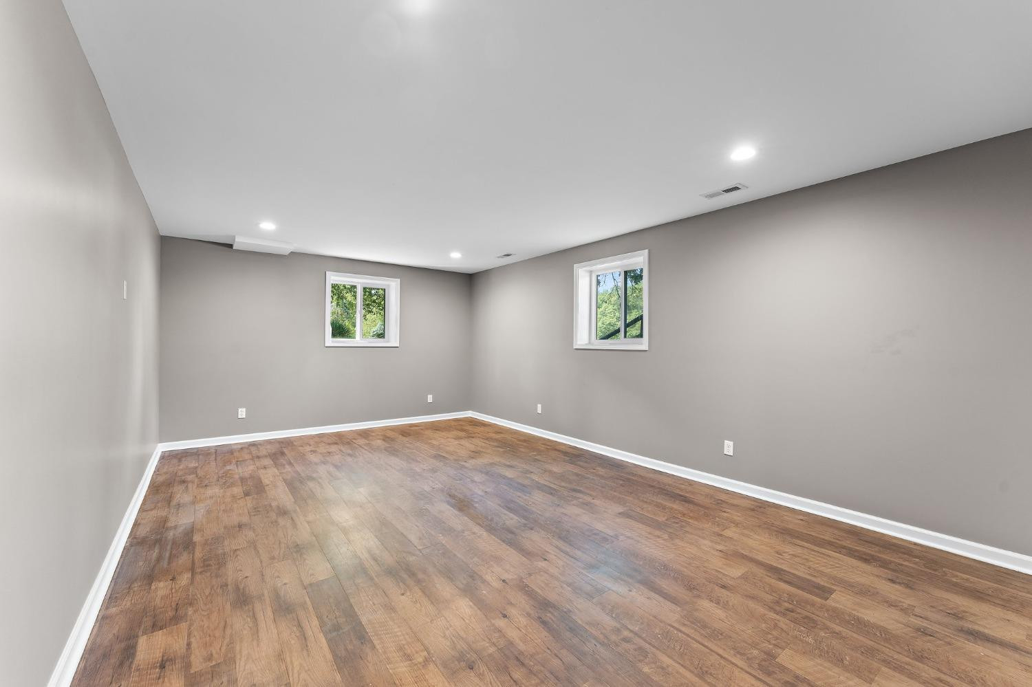 10983 Potomac Drive Demotte, IN 46310 - Photo 17 of 18 a view of an empty room with wooden floor and a window