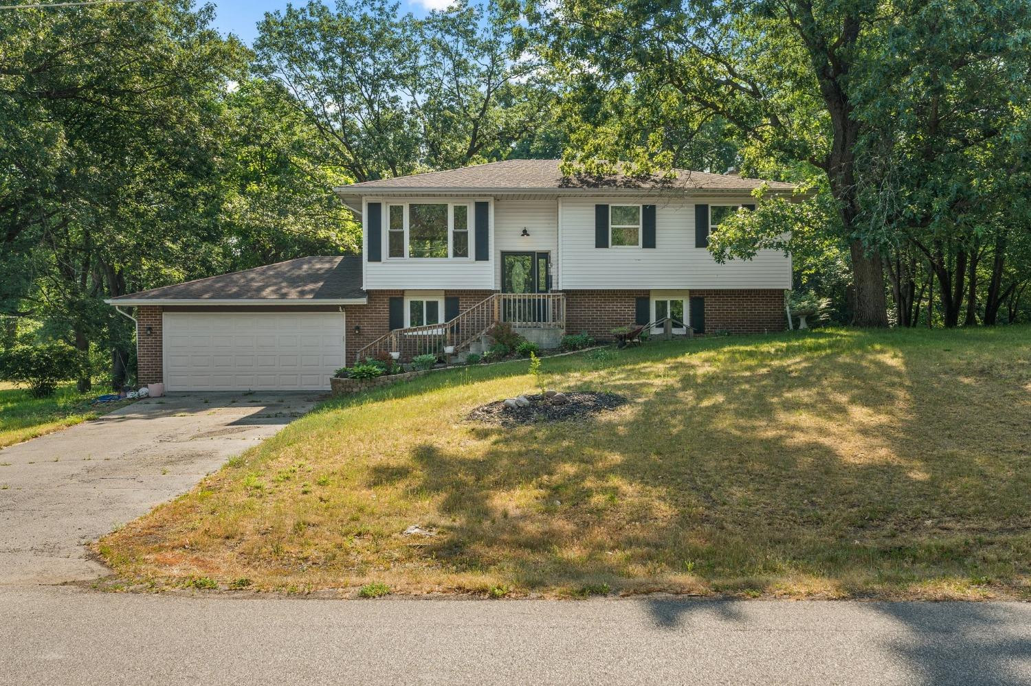 10983 Potomac Drive Demotte, IN 46310 - Photo 2 of 18 a view of a house with a yard and large tree