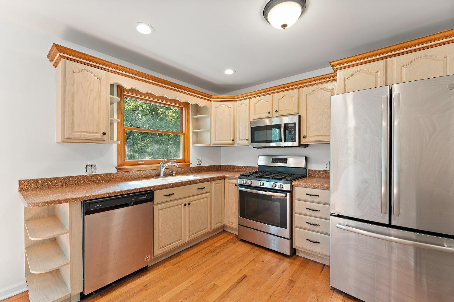 10983 Potomac Drive Demotte, IN 46310 - Photo 5 of 18 a kitchen with stainless steel appliances granite countertop a sink stove and refrigerator