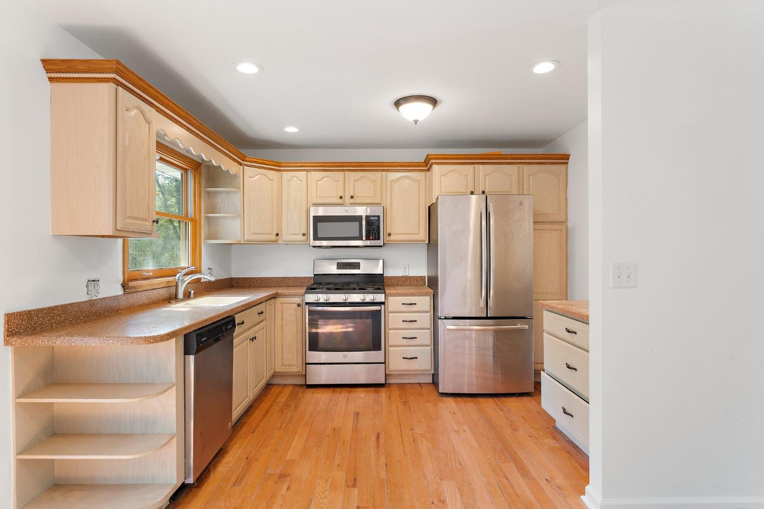 10983 Potomac Drive Demotte, IN 46310 - Photo 7 of 18 a kitchen with stainless steel appliances granite countertop a refrigerator and a stove top oven