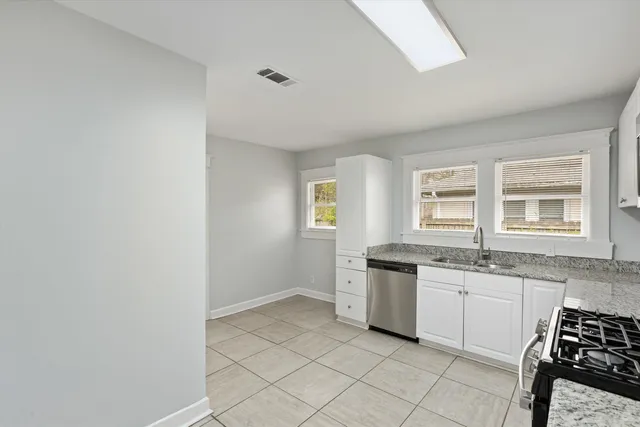 a kitchen with a sink cabinets and window