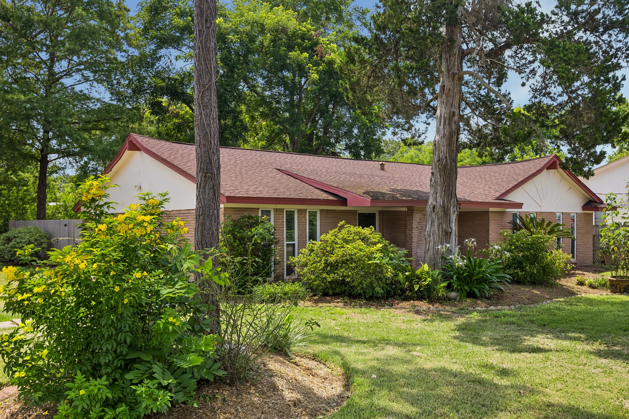 413 Mebane Lane Rosenberg, TX 77471 - Photo 7 of 30 This single-story home with a brick exterior, surrounded by lush landscaping and mature trees, offering a tranquil and private setting.