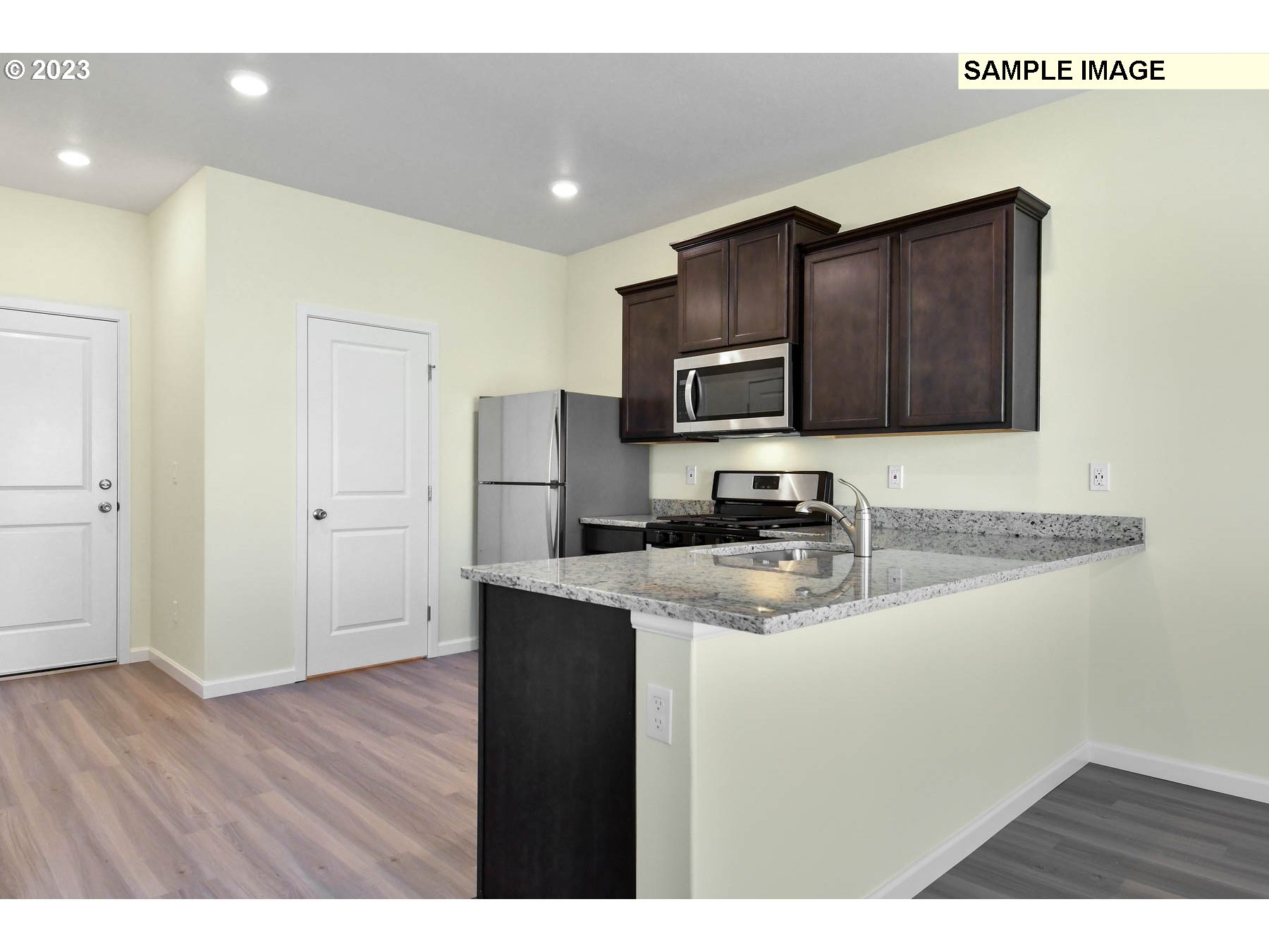 3974 Southwest Knapp Drive Gresham, OR 97080 - Photo 10 of 14 a kitchen with stainless steel appliances granite countertop a sink stove and refrigerator