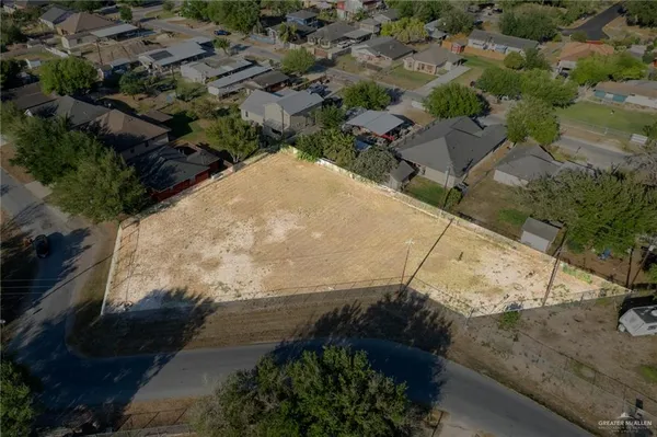an aerial view of a house with a yard