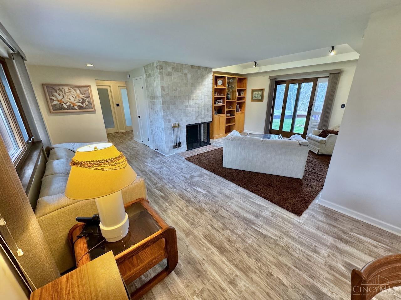 7877 State Road Cincinnati, OH 45255 - Photo 5 of 54 Living room featuring a stunning tile fireplace and walk out to back yard