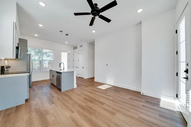 a view of kitchen with sink and wooden floor