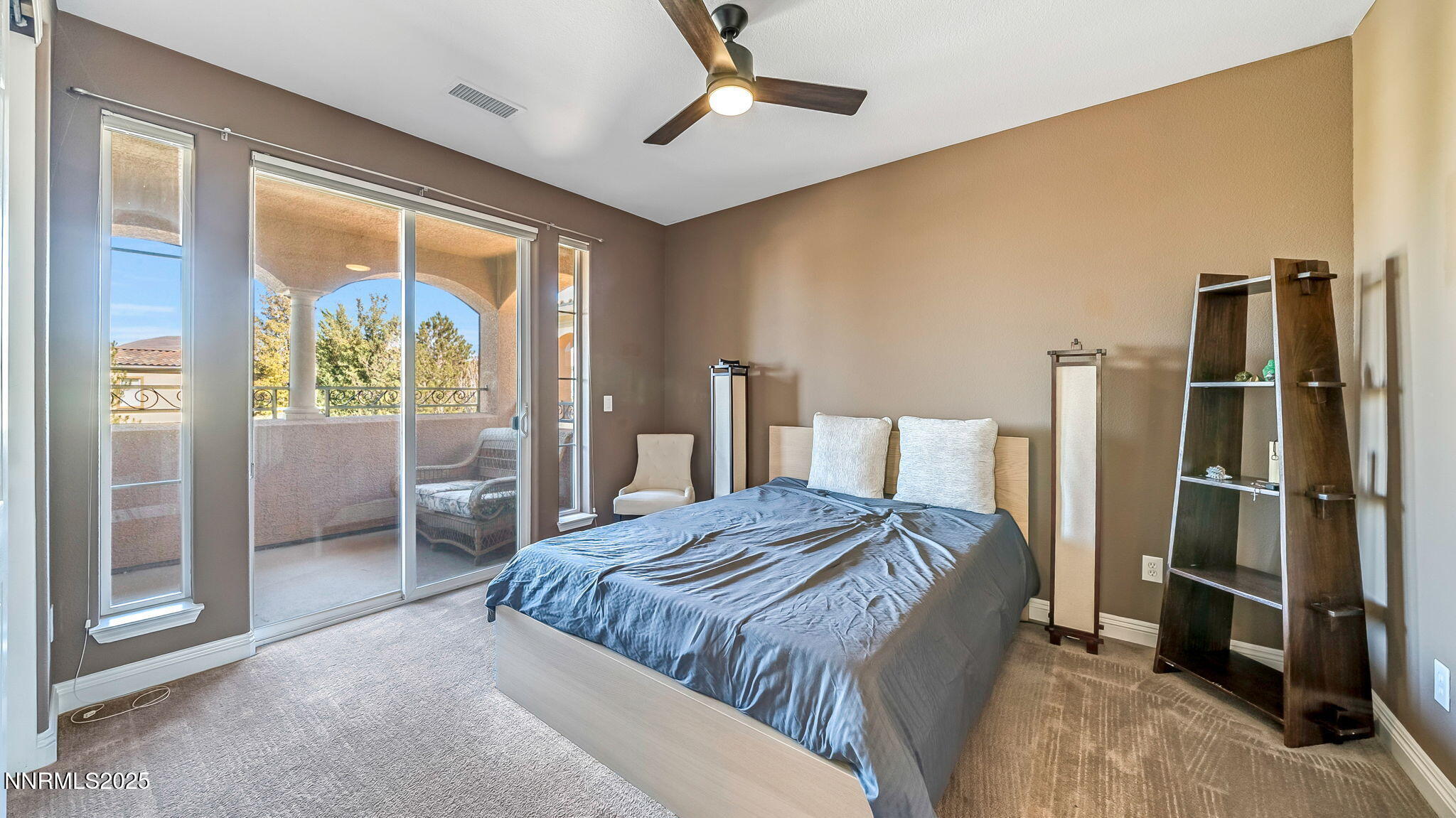 1812 Braemore Drive Reno, NV 89521 - Photo 17 of 26 a spacious bedroom with a bed and a refrigerator