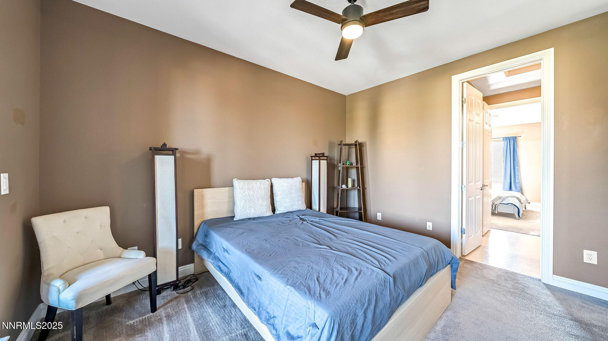 1812 Braemore Drive Reno, NV 89521 - Photo 19 of 26 a spacious bedroom with a bed and a chair