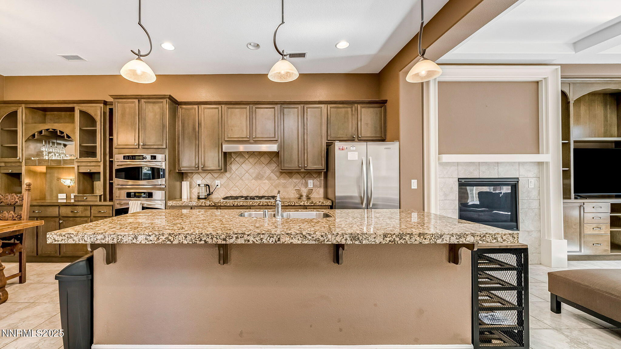 1812 Braemore Drive Reno, NV 89521 - Photo 7 of 26 a large kitchen with kitchen island a large counter space a sink appliances and cabinets