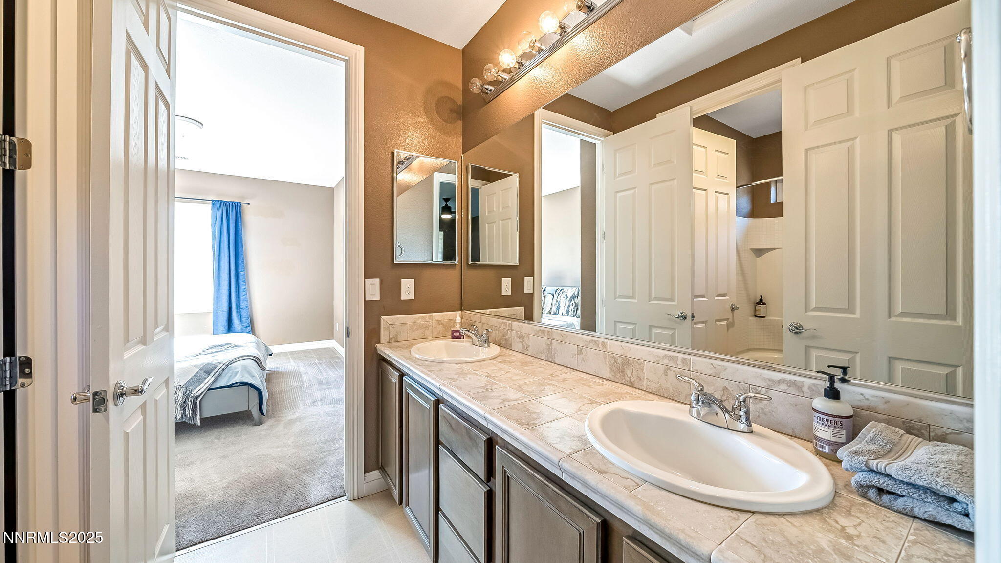 1812 Braemore Drive Reno, NV 89521 - Photo 9 of 26 a en suite bathroom with a granite countertop double vanity sink and a mirror