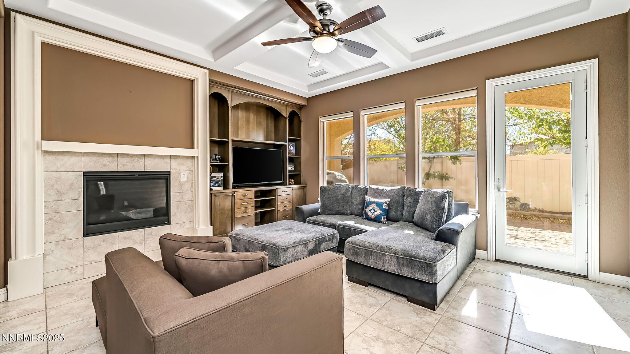 1812 Braemore Drive Reno, NV 89521 - Photo 10 of 26 a living room with furniture a flat screen tv and a fireplace