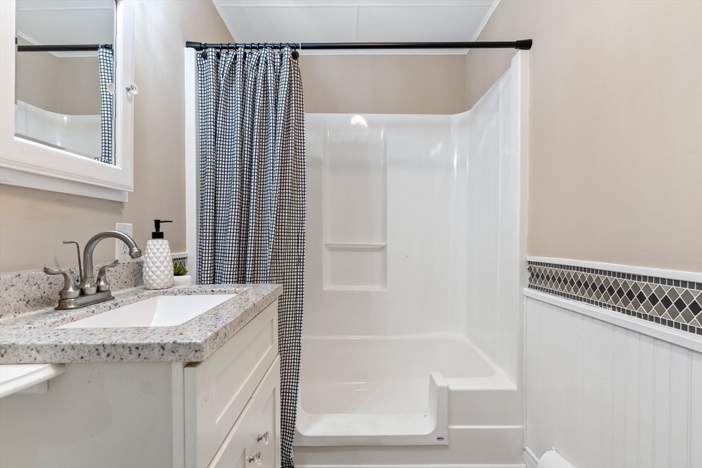 74 County Road East Freetown, MA 02717 - Photo 15 of 40 a bathroom with a granite countertop sink and a mirror