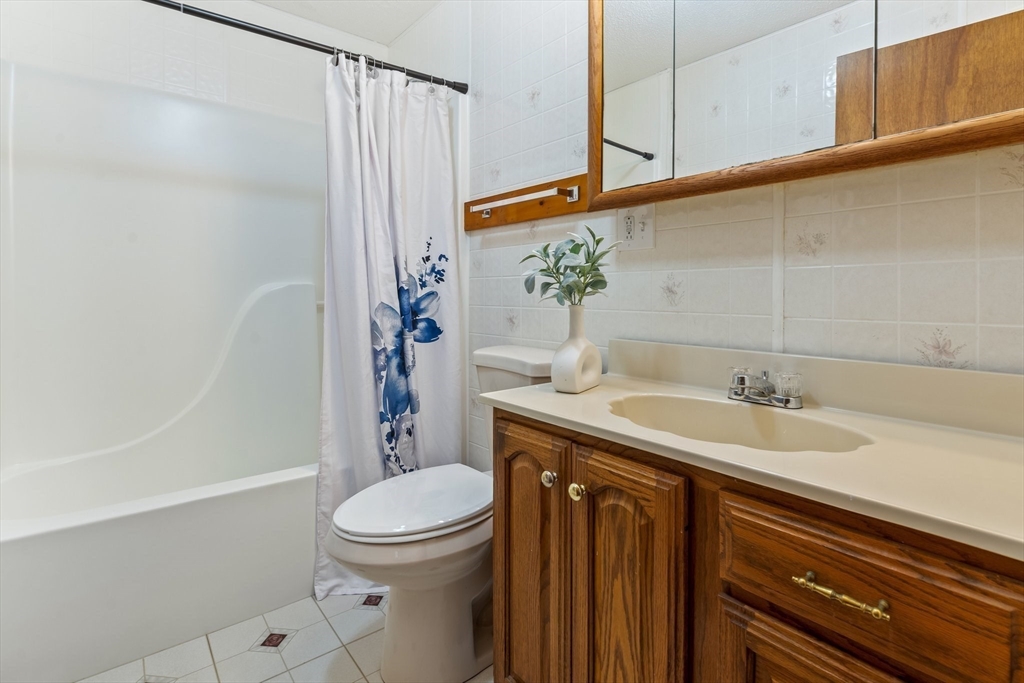 74 County Road East Freetown, MA 02717 - Photo 30 of 40 a bathroom with a granite countertop sink toilet and shower