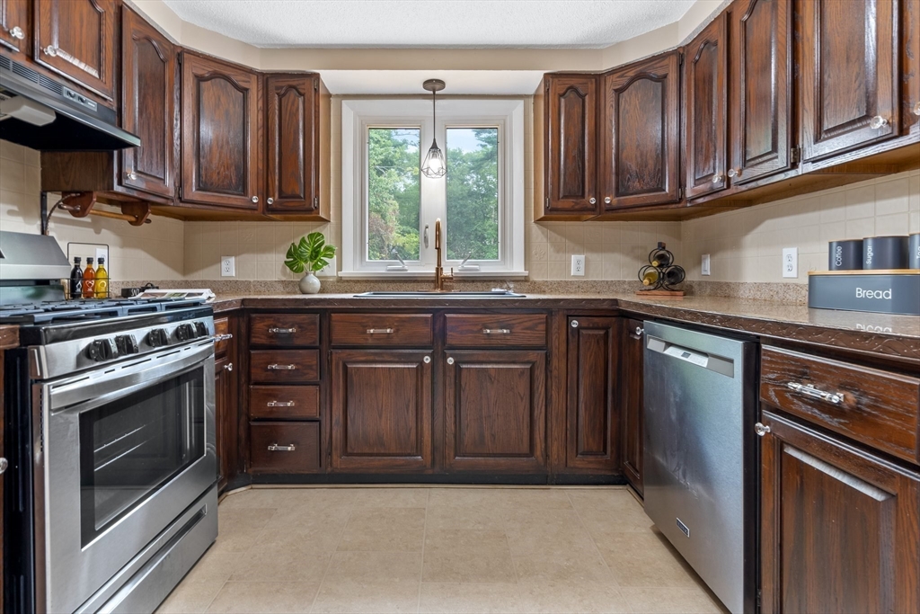 74 County Road East Freetown, MA 02717 - Photo 8 of 40 a kitchen with stainless steel appliances granite countertop a stove a sink dishwasher and a microwave