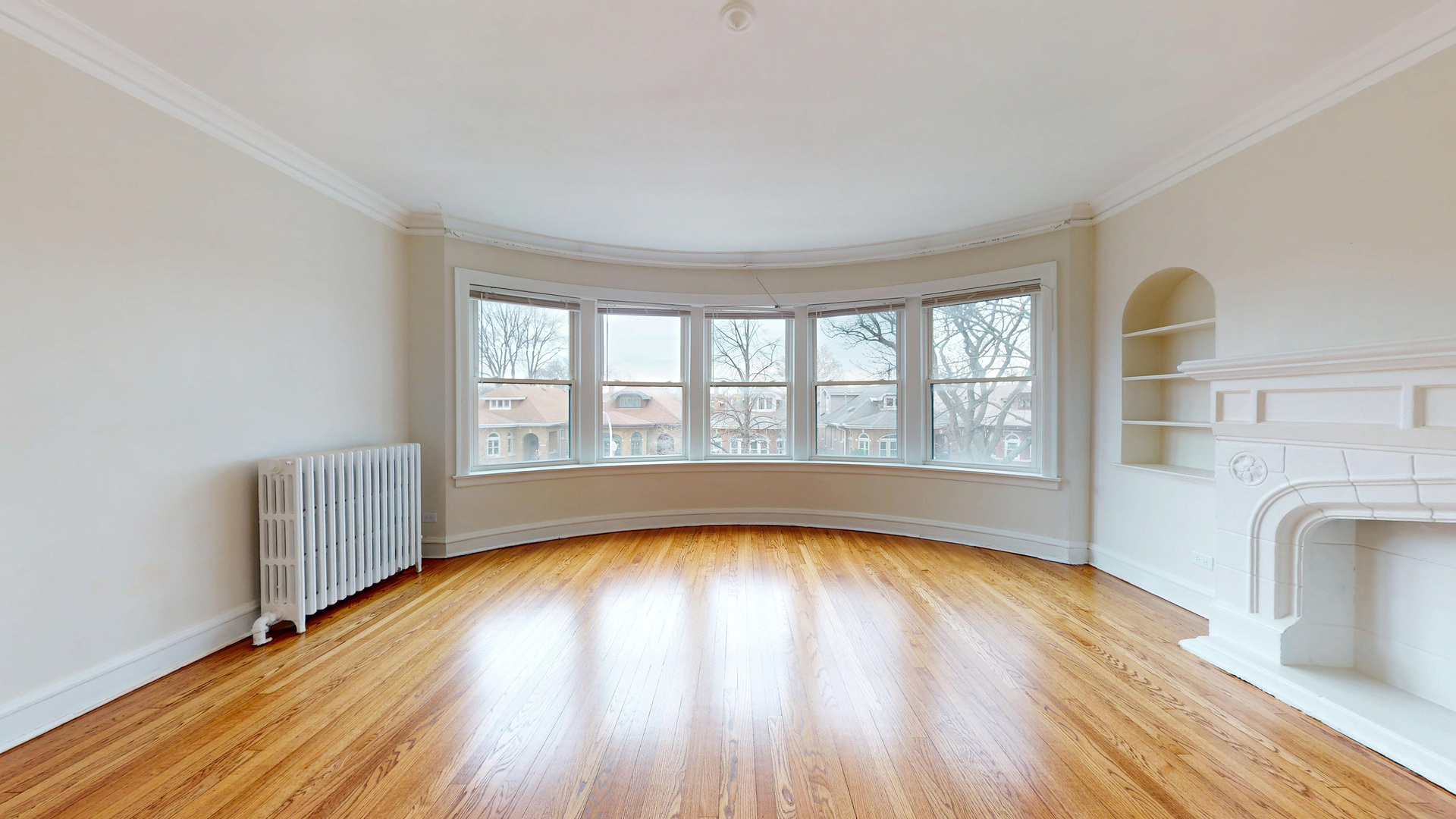 6738 North Rockwell Street, Unit 2 Chicago, IL 60645 - Photo 3 of 13 a view of empty room with wooden floor and fan