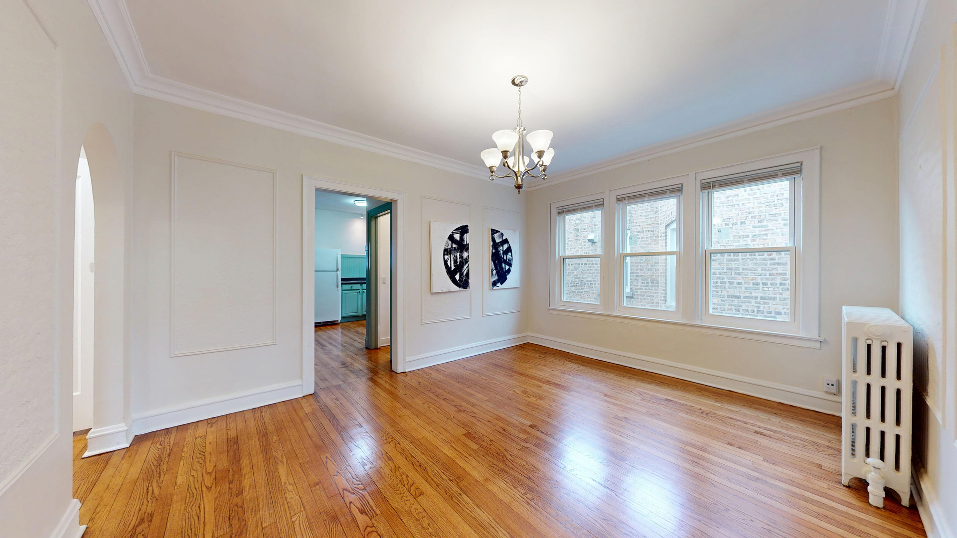 6738 North Rockwell Street, Unit 2 Chicago, IL 60645 - Photo 5 of 13 a view of an empty room with window and wooden floor