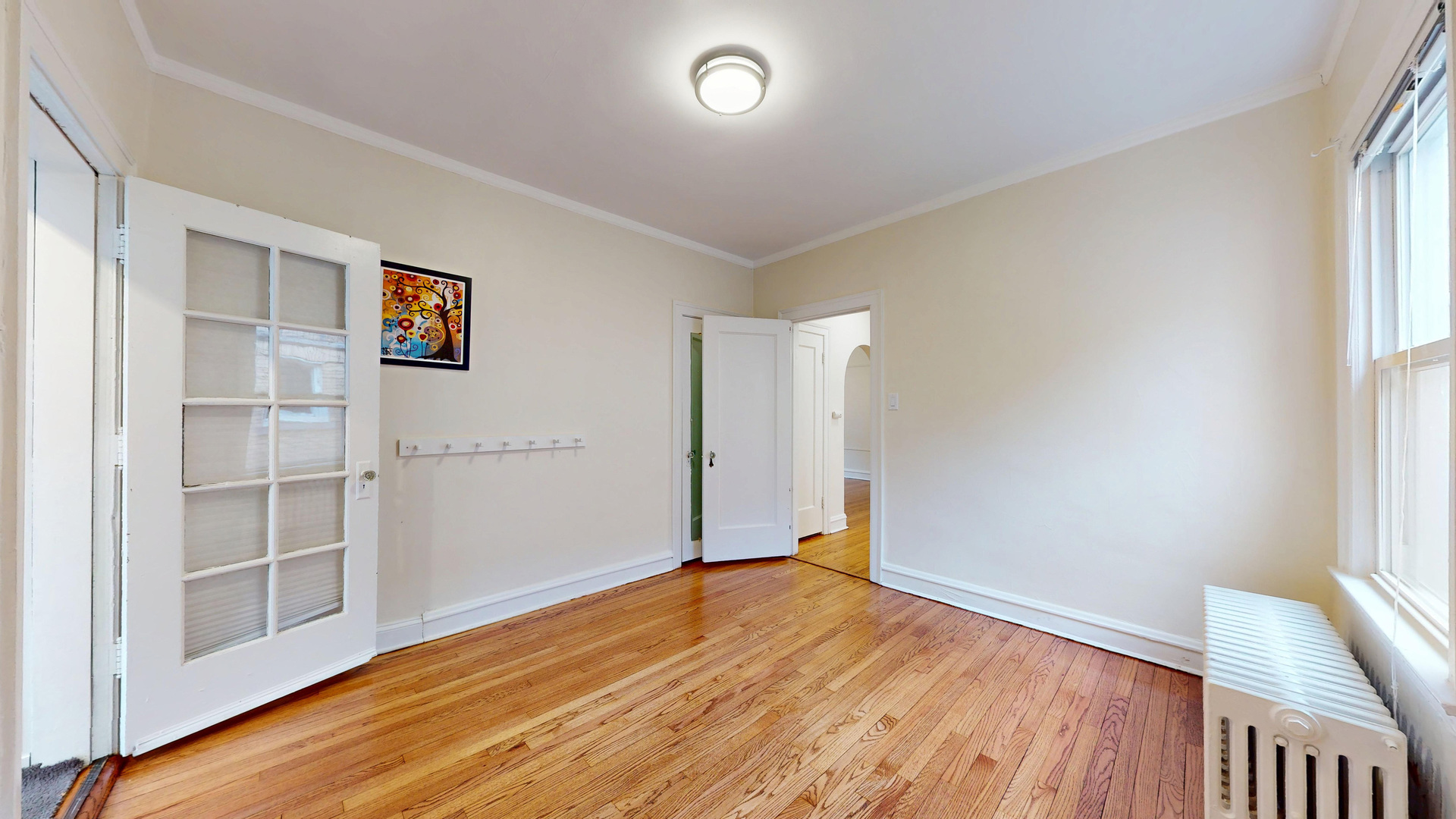 6738 North Rockwell Street, Unit 2 Chicago, IL 60645 - Photo 10 of 13 an empty room with wooden floor and window