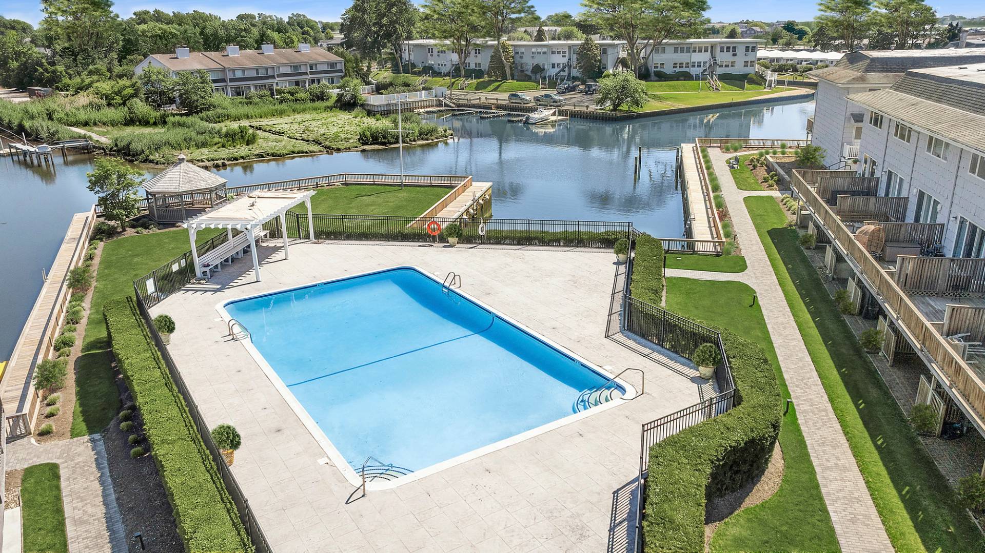 3004 Mitchell Road Westhampton Beach, NY 11978 - Photo 15 of 24 a view of a swimming pool with outdoor seating and lake view