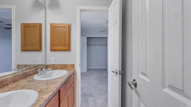 a bathroom with double sink and a mirror