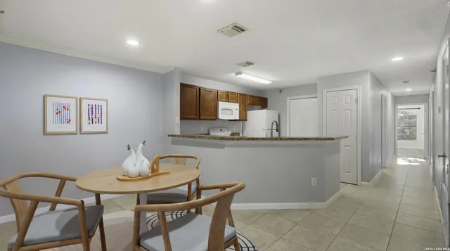 a kitchen with a table and chairs in it