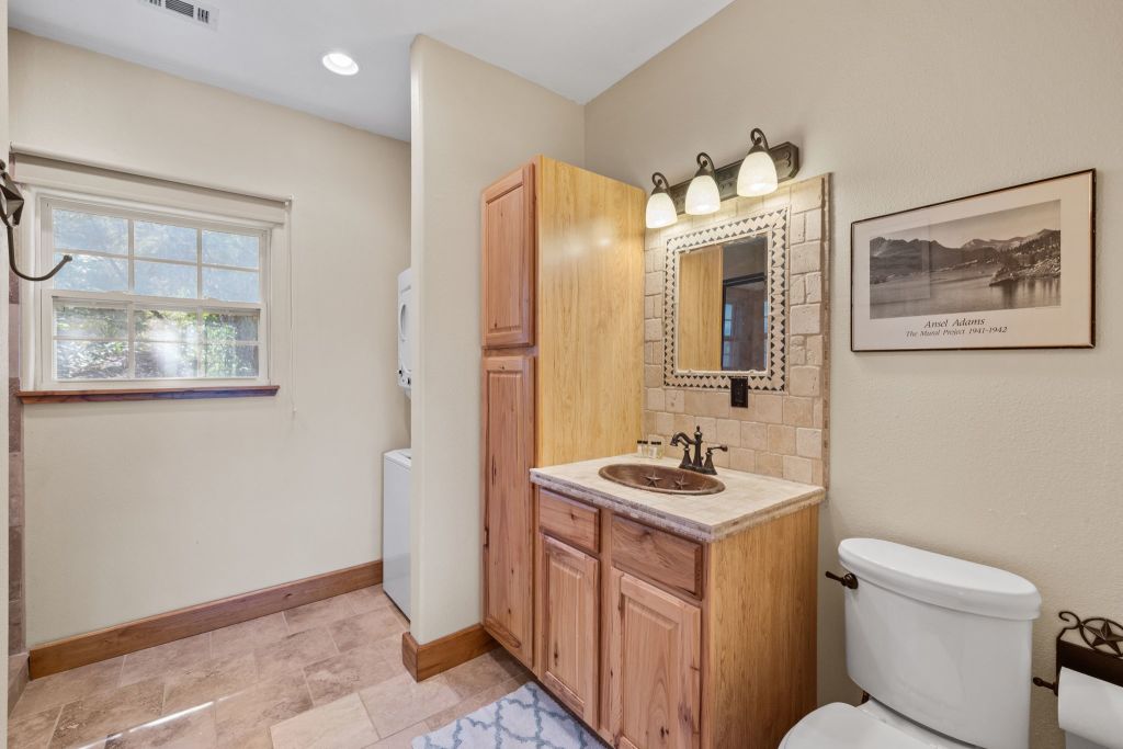 10800 Beach Road Leander, TX 78641 - Photo 28 of 39 Rustic vanity and warm tiled floors define this well-appointed bathroom.